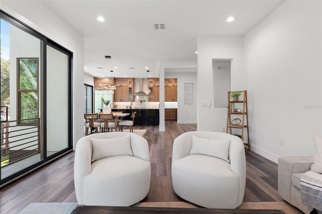 living room with dark wood-type flooring and a chandelier