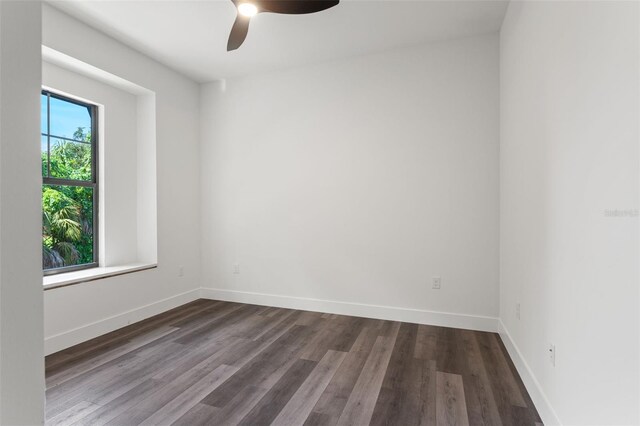 empty room featuring ceiling fan and dark hardwood / wood-style floors