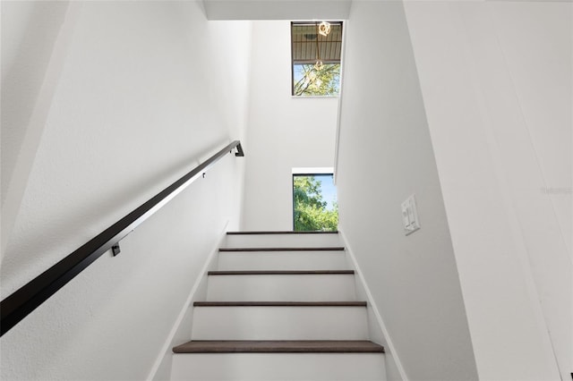 stairs featuring a high ceiling and a wealth of natural light