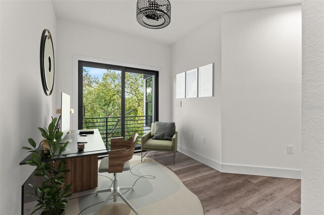 living area with light wood-type flooring and a chandelier