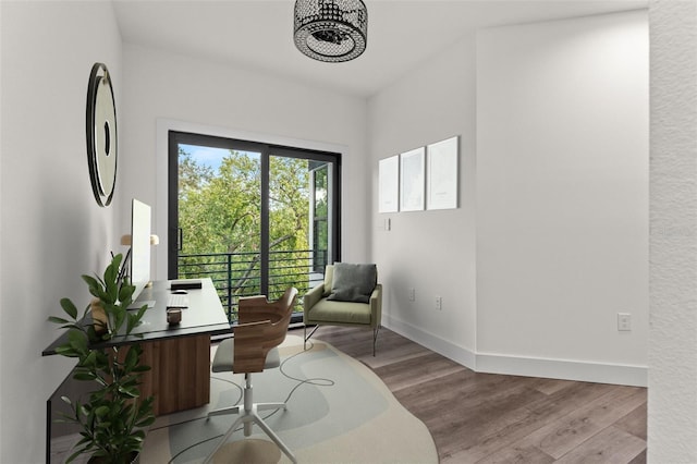 living area featuring baseboards and wood finished floors