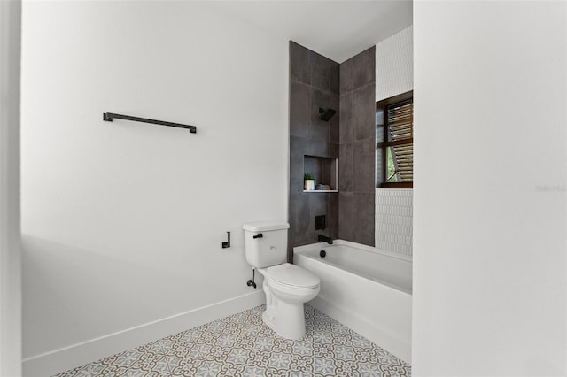 bathroom with tile patterned flooring, baseboards, shower / bathing tub combination, and toilet