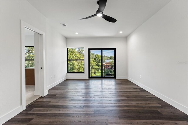 spare room featuring ceiling fan and dark hardwood / wood-style floors