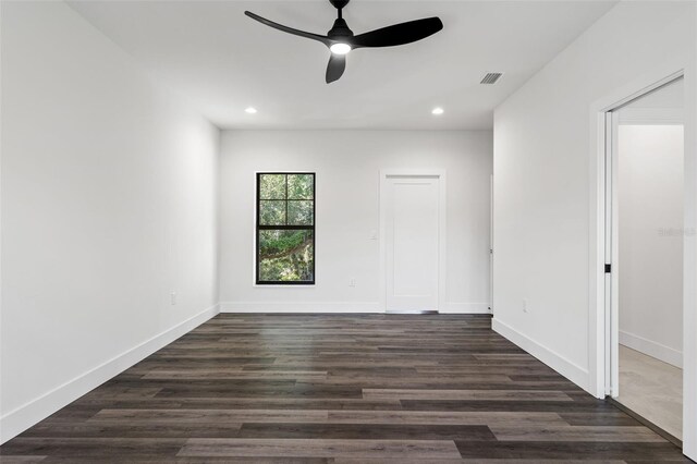 spare room with ceiling fan and dark hardwood / wood-style flooring