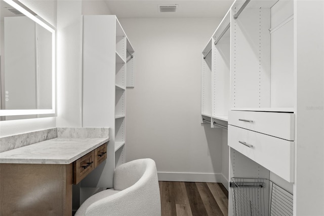 walk in closet featuring dark wood-style floors and visible vents