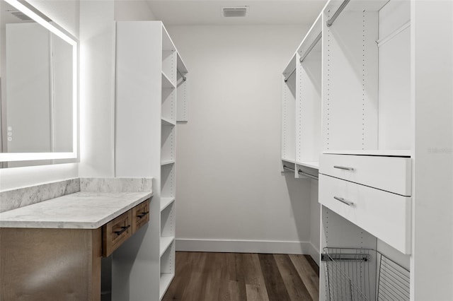 spacious closet featuring dark wood-type flooring