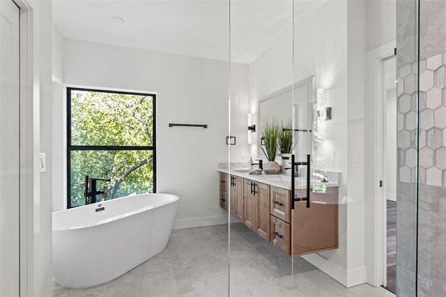 bathroom featuring vanity and a tub