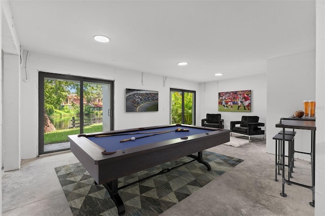 game room featuring unfinished concrete flooring and pool table