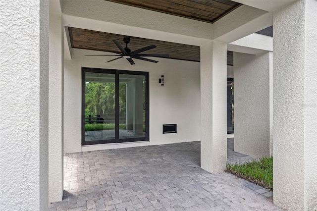 property entrance featuring a ceiling fan, a patio, and stucco siding