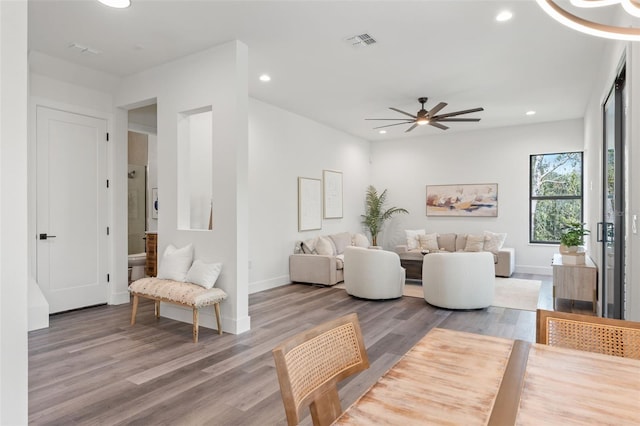 living room featuring ceiling fan and hardwood / wood-style floors