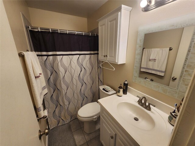 bathroom featuring curtained shower, tile patterned flooring, toilet, and vanity