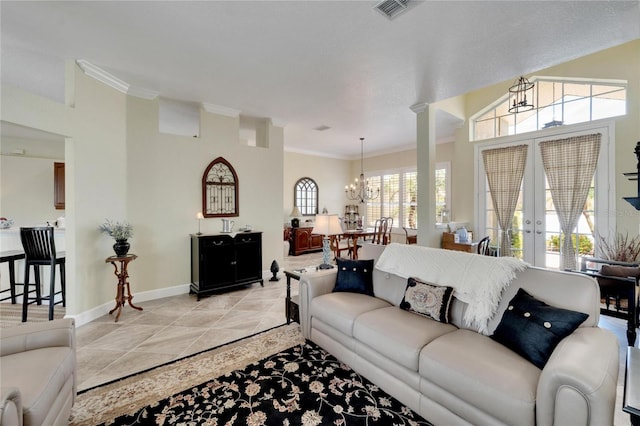 tiled living room with french doors, crown molding, and a chandelier