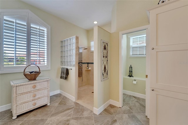 bathroom featuring tile patterned floors and tiled shower