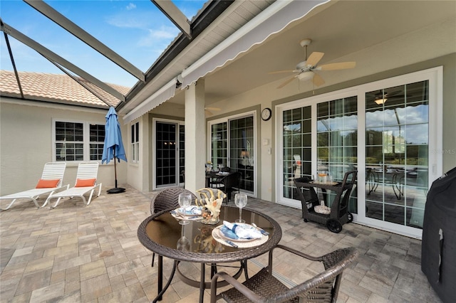 view of patio featuring a lanai and ceiling fan