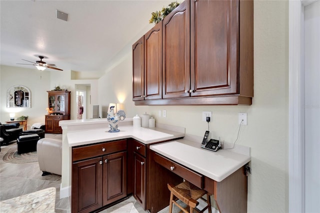 kitchen featuring ceiling fan and kitchen peninsula