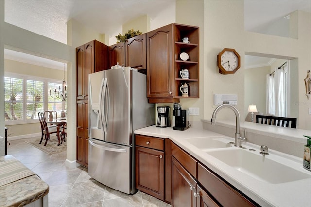 kitchen featuring sink, stainless steel fridge with ice dispenser, a notable chandelier, light tile patterned flooring, and ornamental molding