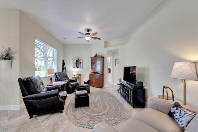 living room with light tile patterned floors and ceiling fan