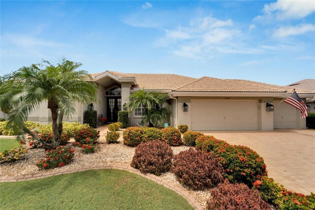 mediterranean / spanish-style home with a garage