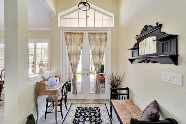 doorway to outside featuring crown molding and french doors