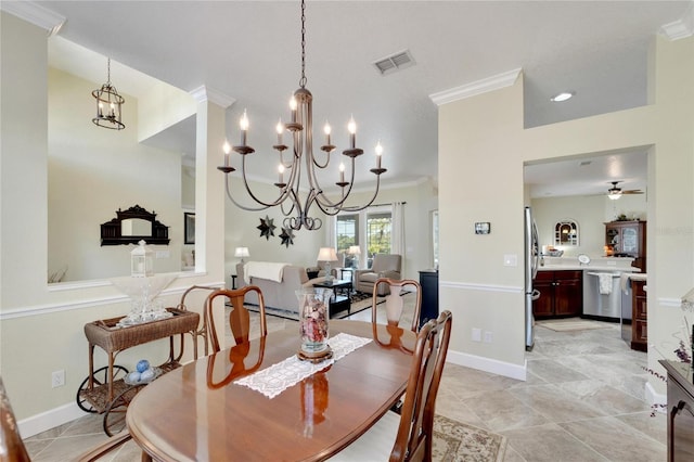 dining area featuring ceiling fan with notable chandelier and ornamental molding