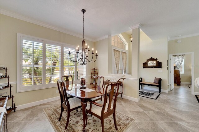 dining room featuring crown molding, a healthy amount of sunlight, and a notable chandelier