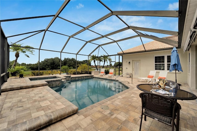 view of swimming pool with glass enclosure, an in ground hot tub, and a patio area