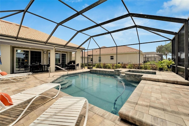 view of pool featuring an in ground hot tub, a patio, and a lanai