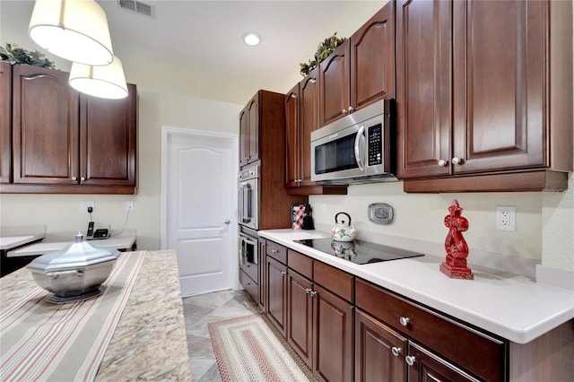 kitchen featuring light tile patterned floors, black electric cooktop, and double wall oven