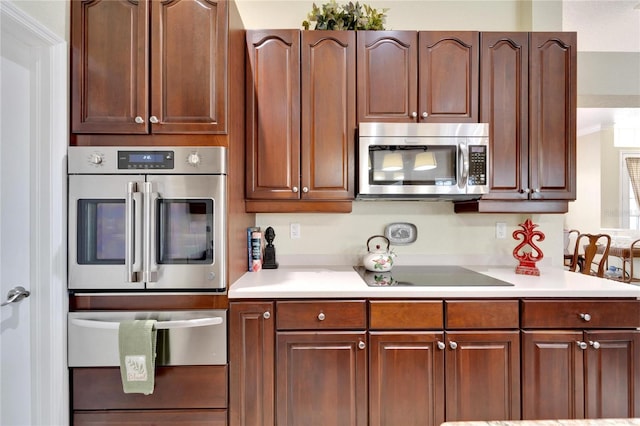 kitchen featuring ornamental molding and appliances with stainless steel finishes