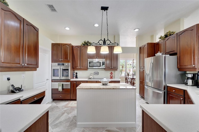 kitchen with a center island, pendant lighting, and appliances with stainless steel finishes