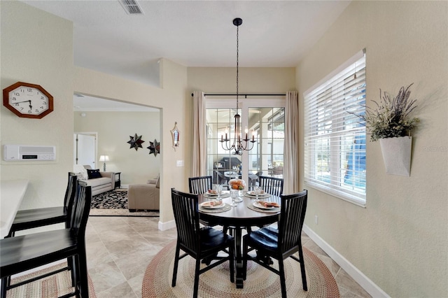 tiled dining area with a chandelier