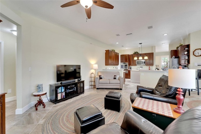 living room with ceiling fan and light tile patterned floors