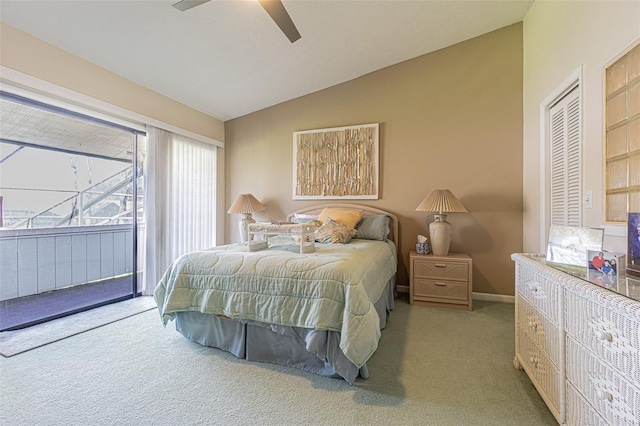 bedroom with a closet, ceiling fan, light carpet, and vaulted ceiling