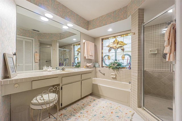 bathroom with vanity, shower with separate bathtub, and tile patterned flooring