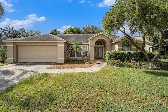 ranch-style home with a front lawn and a garage