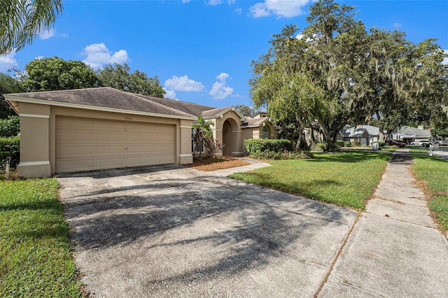 view of front of property featuring a garage and a front lawn