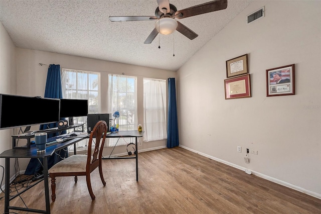 office area with lofted ceiling, hardwood / wood-style floors, ceiling fan, and a textured ceiling