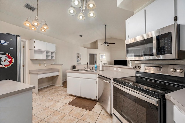 kitchen with ceiling fan with notable chandelier, stainless steel appliances, sink, vaulted ceiling, and white cabinets