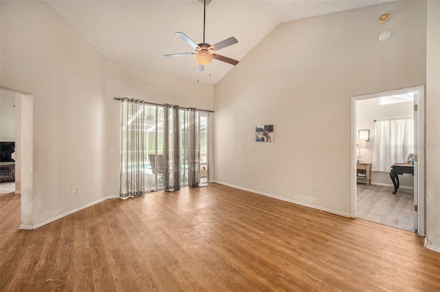 spare room with ceiling fan, high vaulted ceiling, and light hardwood / wood-style floors