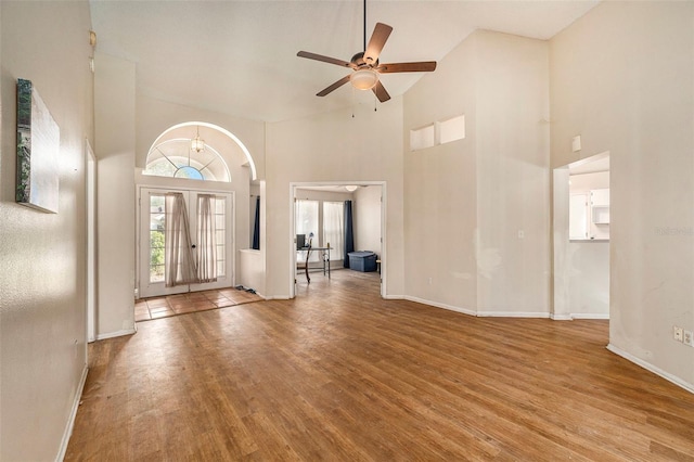 foyer entrance with ceiling fan, high vaulted ceiling, and light hardwood / wood-style floors