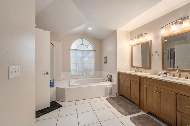 bathroom with vanity, vaulted ceiling, separate shower and tub, and tile patterned floors