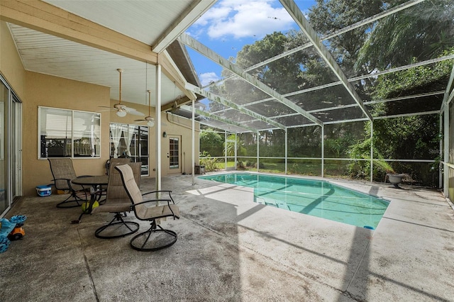 view of pool featuring ceiling fan, a patio, and a lanai