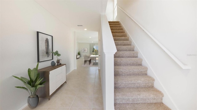 staircase with tile patterned flooring, visible vents, and recessed lighting