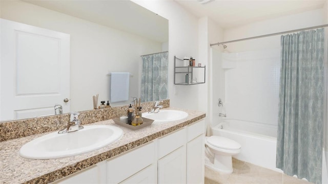 bathroom featuring double vanity, a sink, toilet, and shower / bath combo with shower curtain