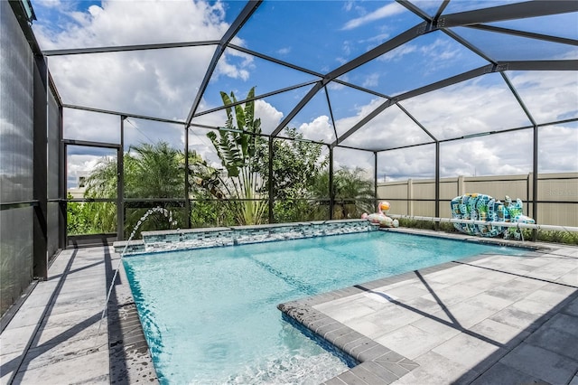 view of swimming pool with a patio area, a lanai, and pool water feature