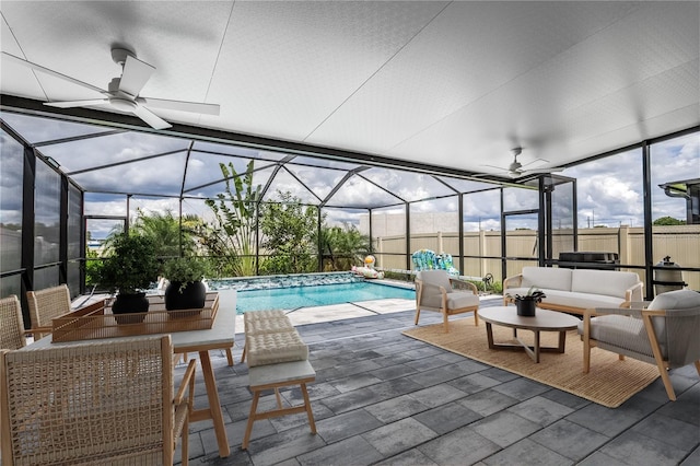 view of swimming pool featuring an outdoor living space, a patio, and glass enclosure