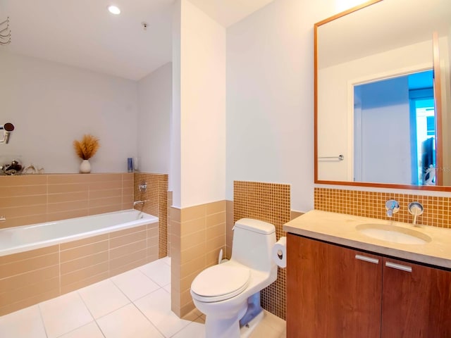 bathroom featuring vanity, tiled bath, tile patterned floors, and toilet