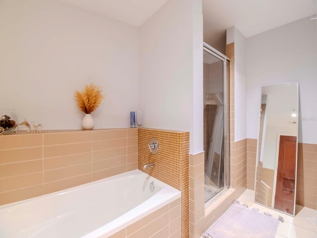 bathroom featuring shower with separate bathtub