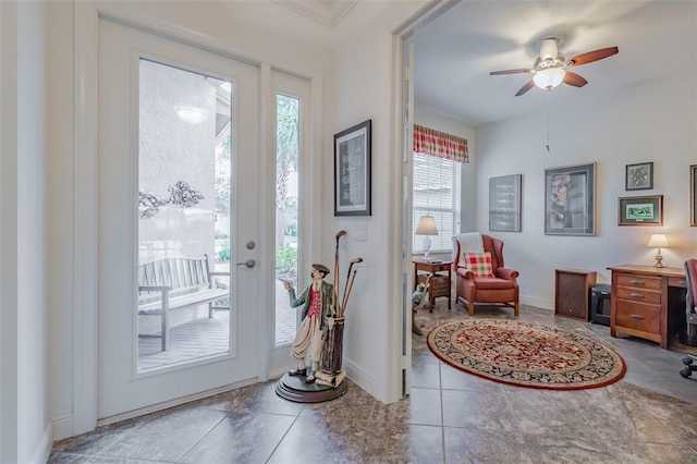 doorway featuring tile patterned flooring and ceiling fan