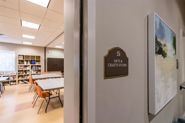 interior space with a paneled ceiling